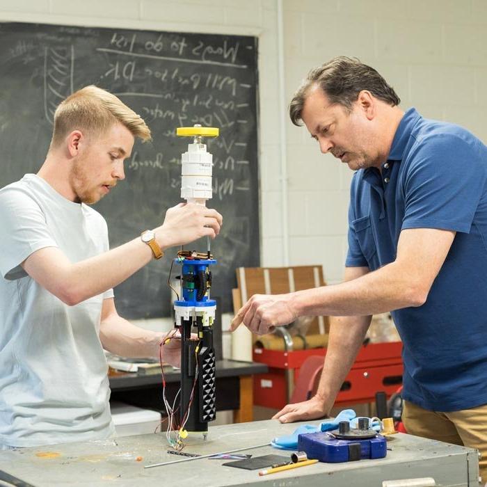 Professor and student work on project in lab